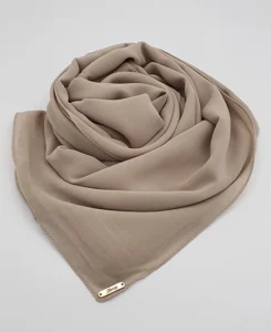 Introducing our Premium Dark Nude Chiffon Hijab, crafted from smooth, soft, and non-transparent fabric. This lightweight hijab offers an elegant drape for a sophisticated look, perfect for those who value both comfort and style.