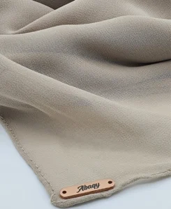 Introducing our Premium Dark Nude Chiffon Hijab, crafted from smooth, soft, and non-transparent fabric. This lightweight hijab offers an elegant drape for a sophisticated look, perfect for those who value both comfort and style.