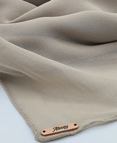 Introducing our Premium Dark Nude Chiffon Hijab, crafted from smooth, soft, and non-transparent fabric. This lightweight hijab offers an elegant drape for a sophisticated look, perfect for those who value both comfort and style.