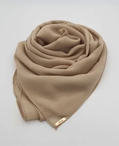 Introducing our Premium Light French Beige Chiffon Hijab, crafted from smooth, soft, and non-transparent fabric. This lightweight hijab offers an elegant drape for a sophisticated look, perfect for those who value both comfort and style.