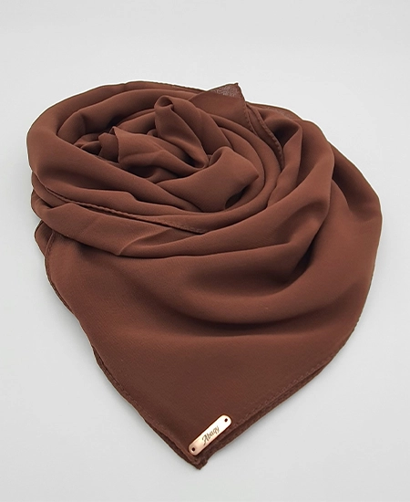 Introducing our Premium Umber Brown Chiffon Hijab, crafted from smooth, soft, and non-transparent fabric. This lightweight hijab offers an elegant drape for a sophisticated look, perfect for those who value both comfort and style.