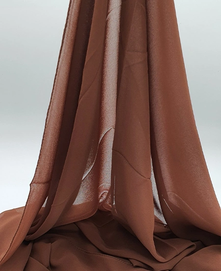 Introducing our Premium Umber Brown Chiffon Hijab, crafted from smooth, soft, and non-transparent fabric. This lightweight hijab offers an elegant drape for a sophisticated look, perfect for those who value both comfort and style.